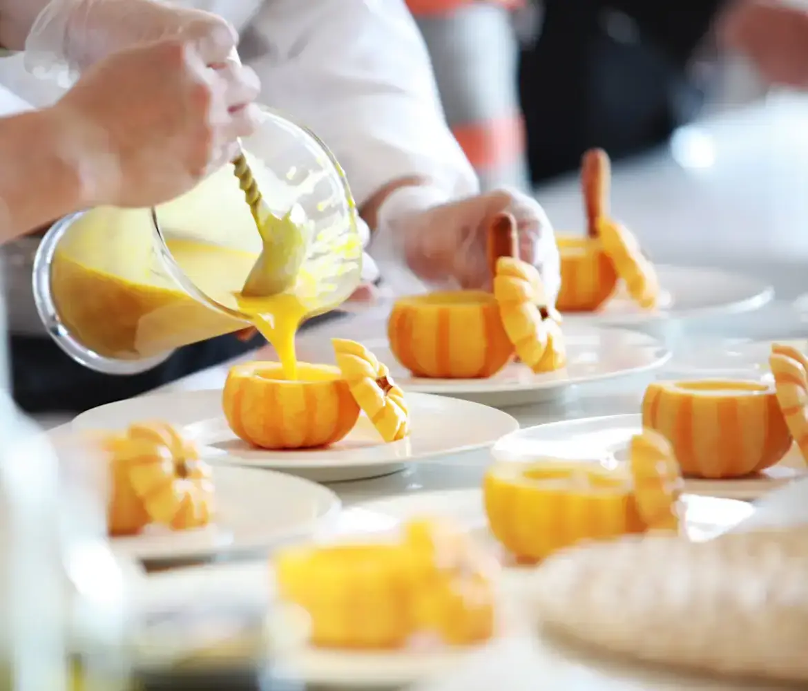Pumpkin soup served in baby pumpkins